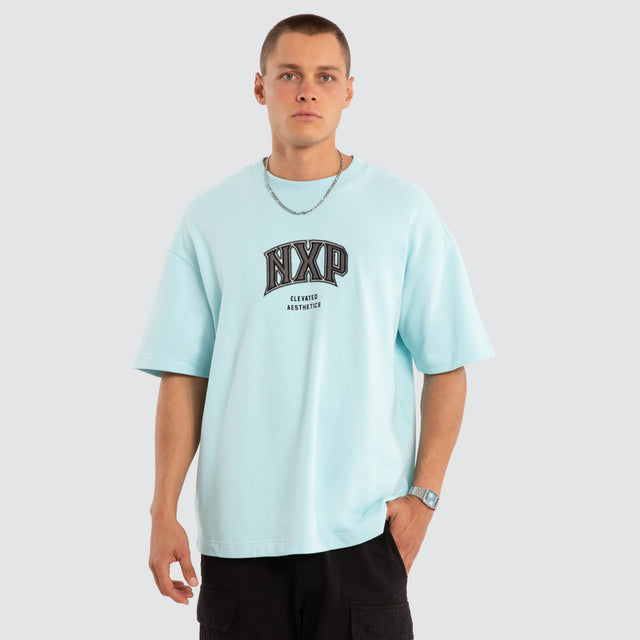 Model wears NXP Factor Loopback Raptor Tee Blue T-Shirts in Blue - Image 1