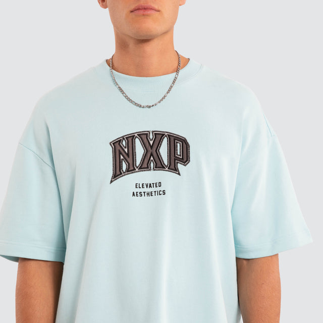 Model wears NXP Factor Loopback Raptor Tee Blue T-Shirts in Blue - Image 4