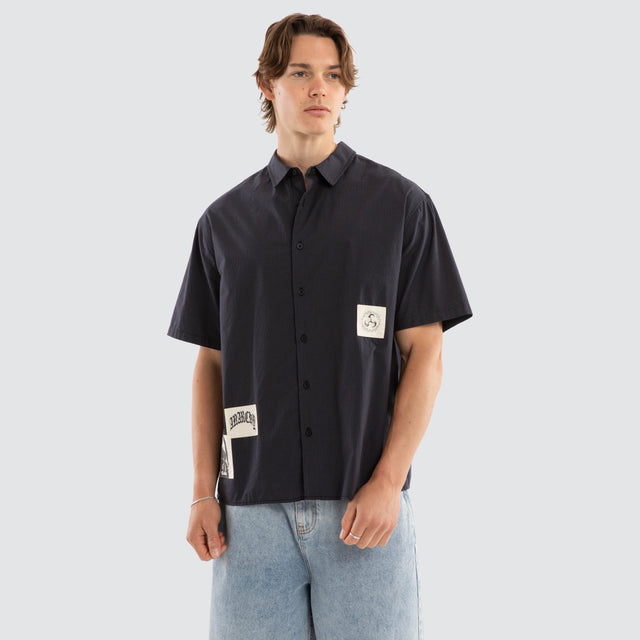 Model wears Ashfall SS Skate Shirt Asphalt Check Short Sleeve Shirts Grey – image 1