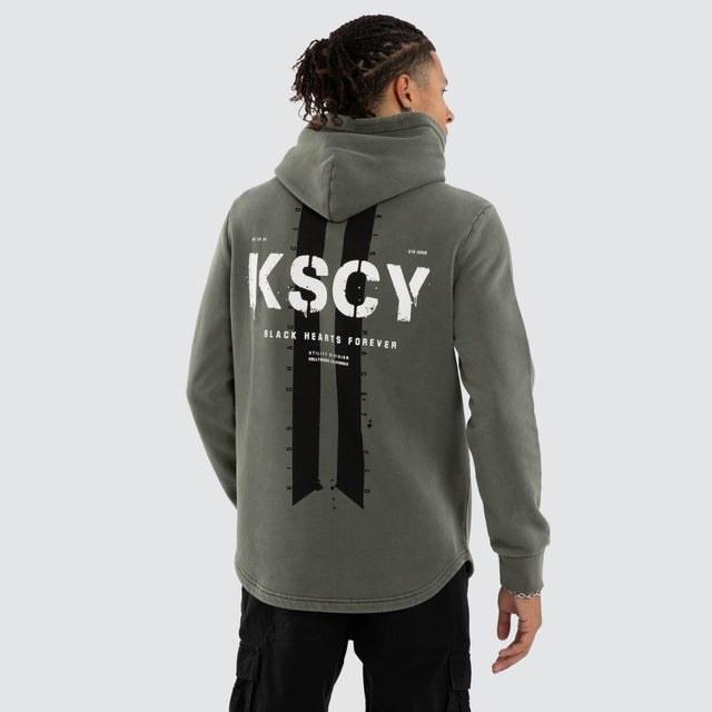 Model wears Inferno Dual Curved Hoodie Pigment Basil Hoodies Green – image 1