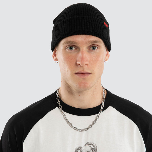 Model wears Record Beanie Jet Black Headwear Black – image 2