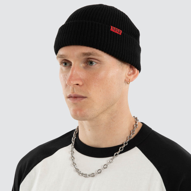Model wears Record Beanie Jet Black Headwear Black – image 3