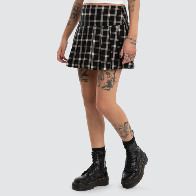 Model wears Tempest Pleated Skirt Black/White Check Skirt Black – image 1