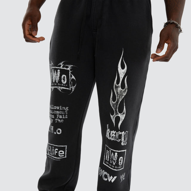 Model wears NWO 4 Life Straight Trackpant Pigment Anthracite Black Trackpants Black – image 6