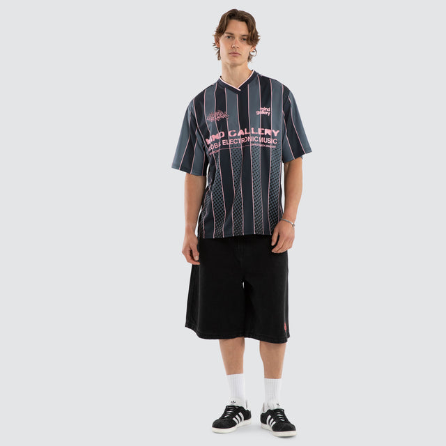 Model wears Metro Strike Football Jersey Black Stripe Jerseys Black – image 5