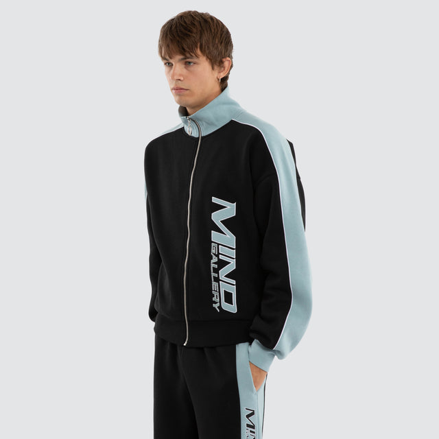 Model wears Audeo Track Zip Jacket Jet Black/Arona Teal Jackets Blue – image 3