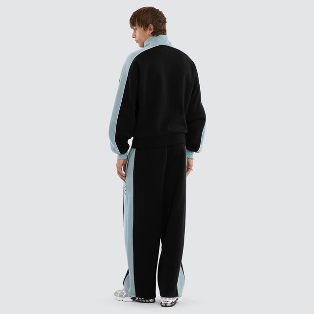 Model wears Audeo Track Zip Jacket Jet Black/Arona Teal Jackets Blue – image 2