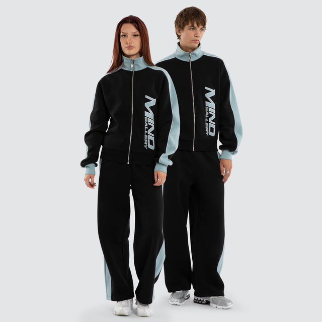 Model wears Audeo Track Zip Jacket Jet Black/Arona Teal Jackets Blue – image 5