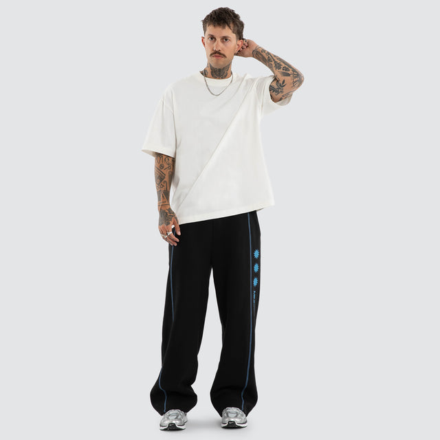 Model wears Stitch Tracksuit Pants Jet Black Trackpants Black – image 4
