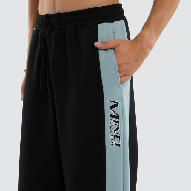 Model wears Grey Cloud Trackpants Jet Black/Arona Teal Trackpants Blue – image 4
