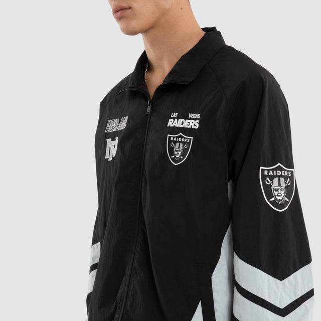 Model wears Las Vegas Raiders NFL Racing Jacket Jet Black/Silver Jackets Black – image 5