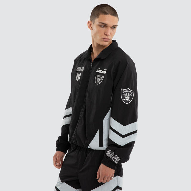 Model wears Las Vegas Raiders NFL Racing Jacket Jet Black/Silver Jackets Black – image 4