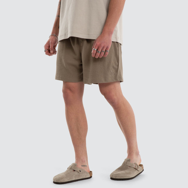 Model wears Matteo 6 Inch Daily Short Olive Shorts Green – image 1