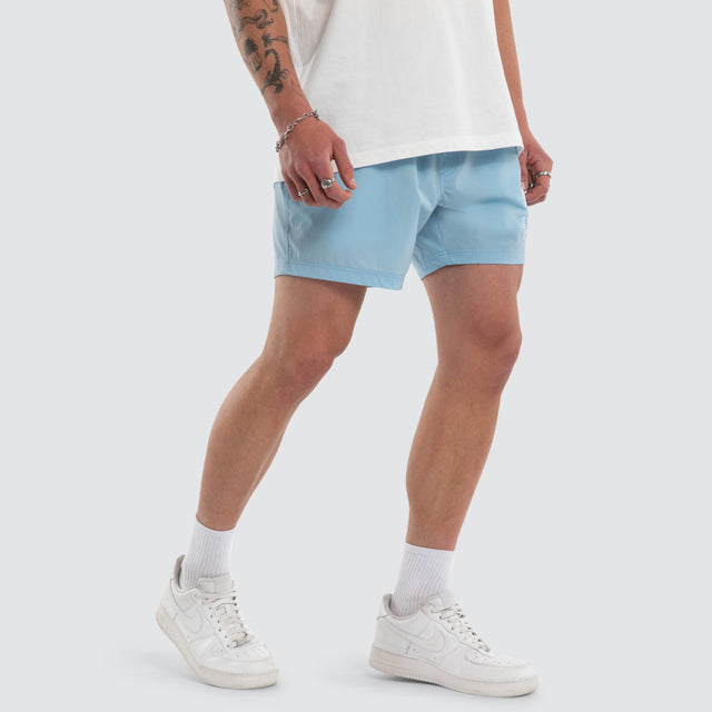 Model wears Coral 6 Inch Swim Short Baby Blue Shorts Blue – image 4