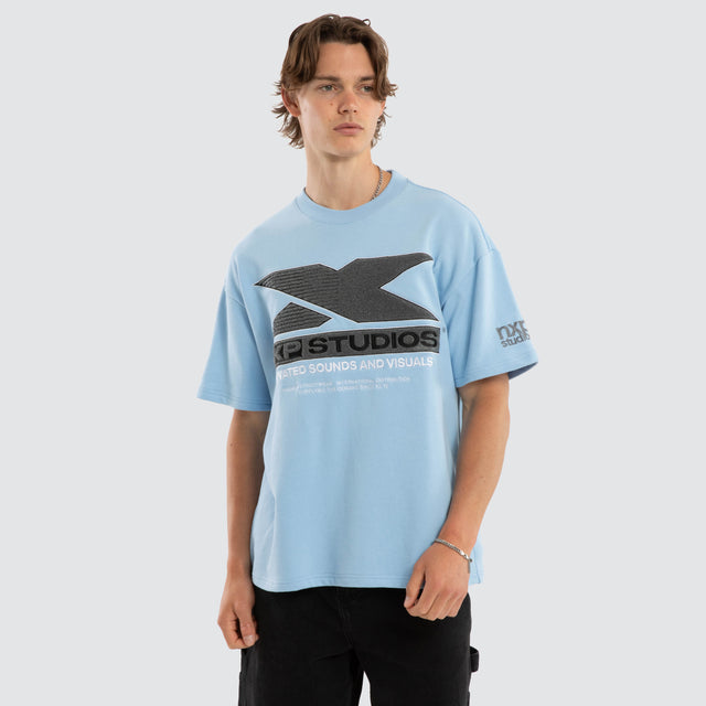 Model wears Exile Loopback Raptor Tee Dutch Canal T-Shirts Blue – image 1
