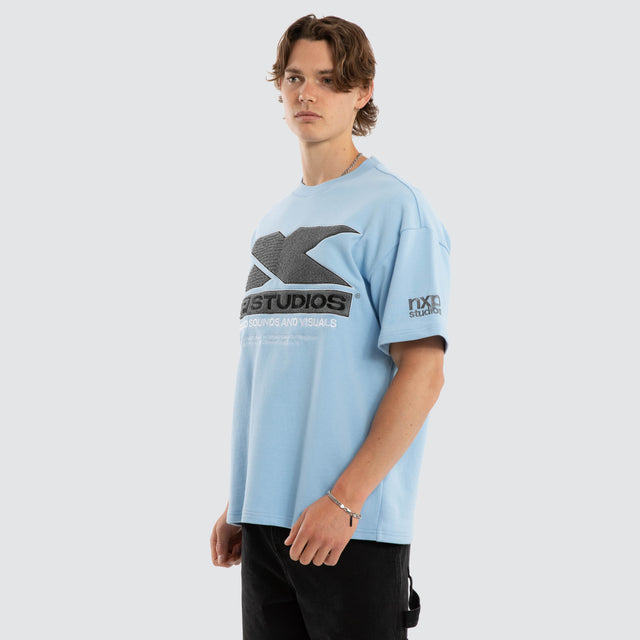 Model wears Exile Loopback Raptor Tee Dutch Canal T-Shirts Blue – image 3