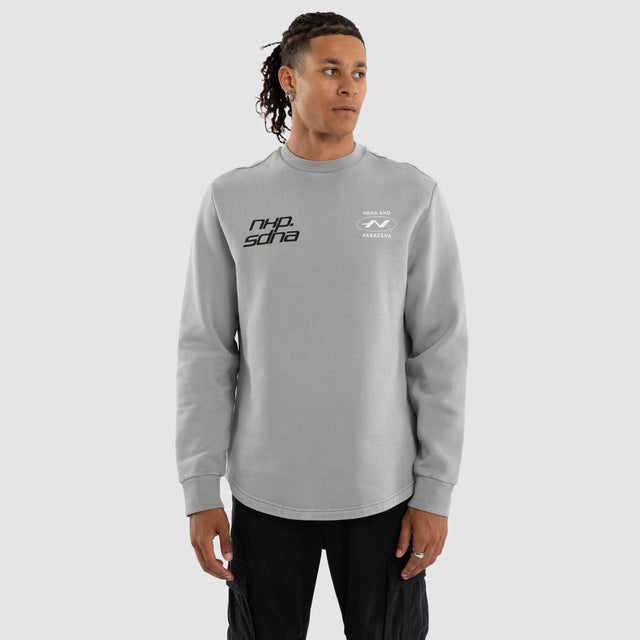 Model wears Independent Curved Sweater Ultimate Grey Jumpers Grey – image 1