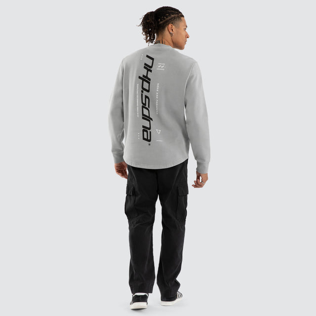 Model wears Independent Curved Sweater Ultimate Grey Jumpers Grey – image 2