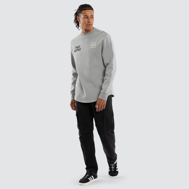 Model wears Independent Curved Sweater Ultimate Grey Jumpers Grey – image 5