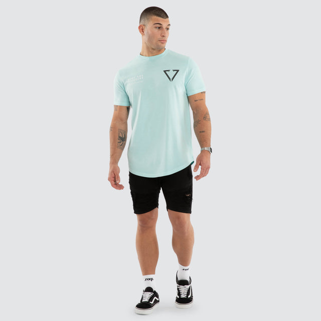 Model wears NXP Eidolon Curved Hem Tee Pigment Blue T-Shirts in Blue - Image 6