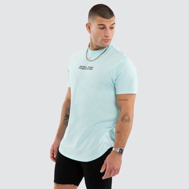 Model wears NXP Dawnrise Curved Hem Tee Blue T-Shirts in Blue - Image 4