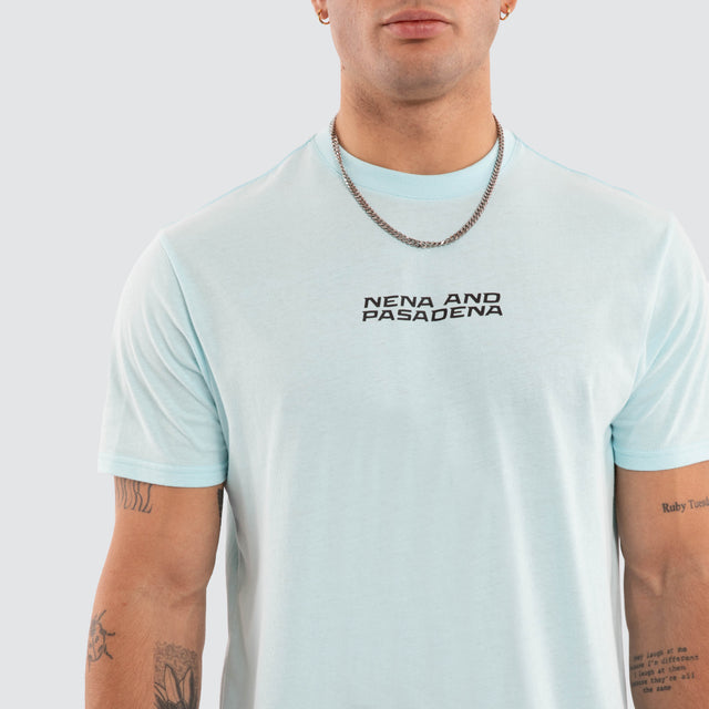 Model wears NXP Dawnrise Curved Hem Tee Blue T-Shirts in Blue - Image 3