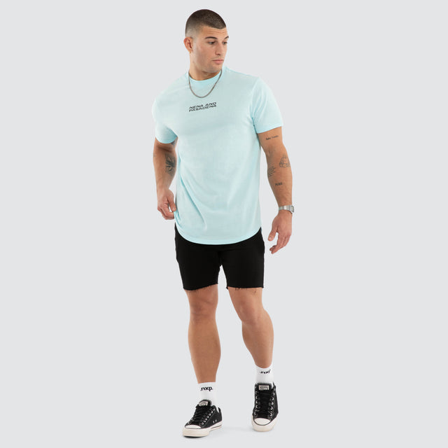Model wears NXP Dawnrise Curved Hem Tee Blue T-Shirts in Blue - Image 6