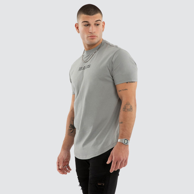 Model wears NXP Dawnrise Curved Hem Tee Grey T-Shirts in Grey - Image 3