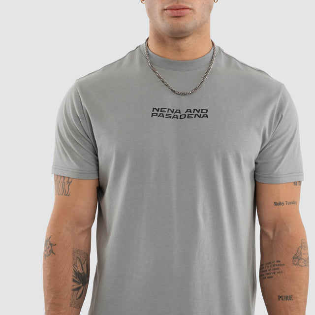 Model wears NXP Dawnrise Curved Hem Tee Grey T-Shirts in Grey - Image 4