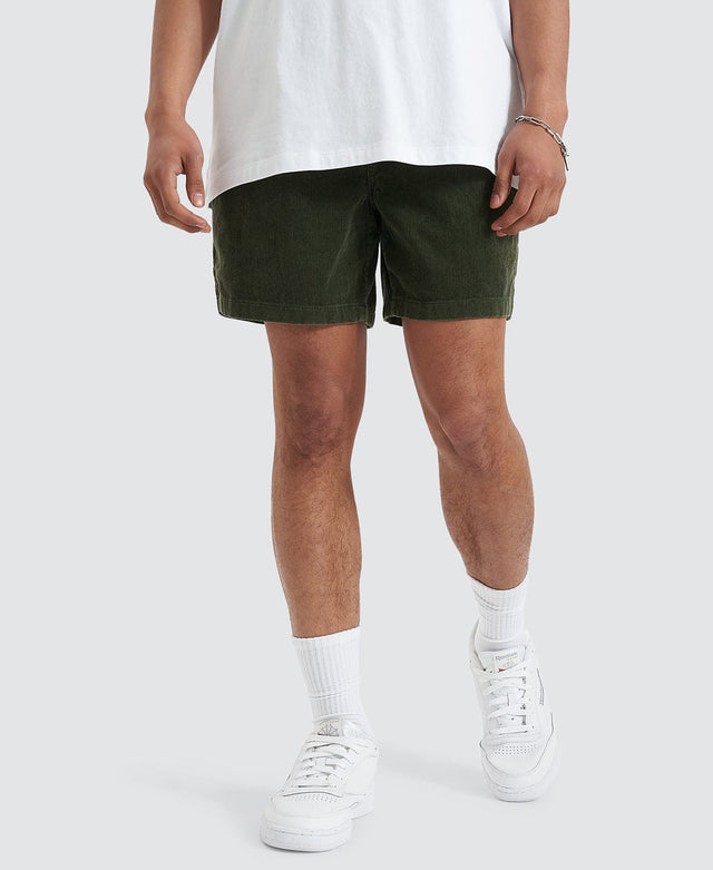 Model wears Nomadic's corduroy walker shorts in khaki