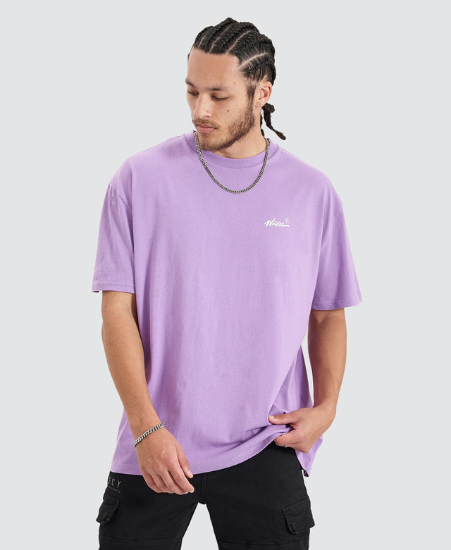 Man wearing a violet purple box fit t-shirt with ribbed crew neckline from Wndrr, featuring the brand's logo in a white coloured cursive font.