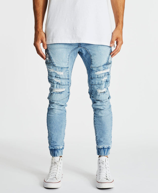 Hydra - men's denim jogger pants in horizon blue with a fitted waist and ripped-styling patched with white jeans, designed by KSCY