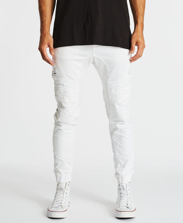 Hydra White denim jogger pants for men with elastic cuffed ankles and distressed detailing by Kiss Chacey