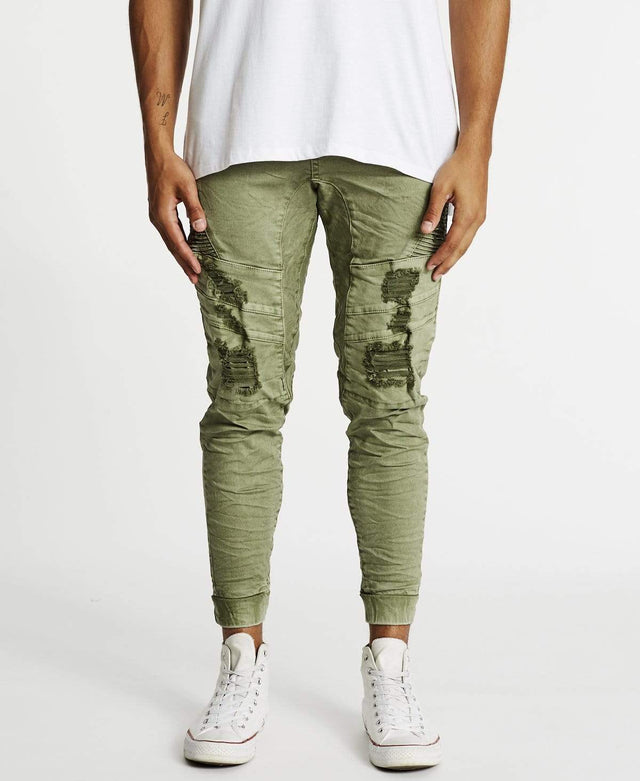 Men's lichen green slim-fit Hydra denim jogger pants with distressed details designed by Kiss Chacey